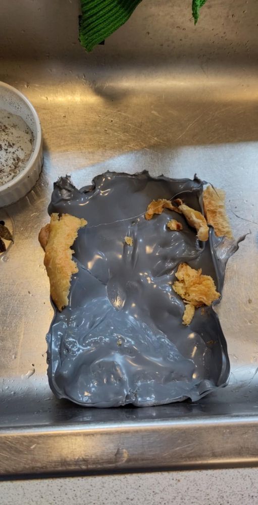 The melted grey plastic lid I forgot to remove when I put the food in the oven 🫣