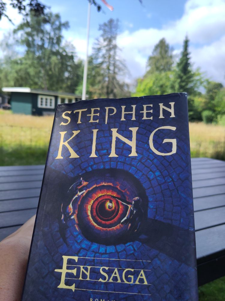 A Stephen King book, "Fairy Tale - En Saga" in Swedish. My garden in the background 