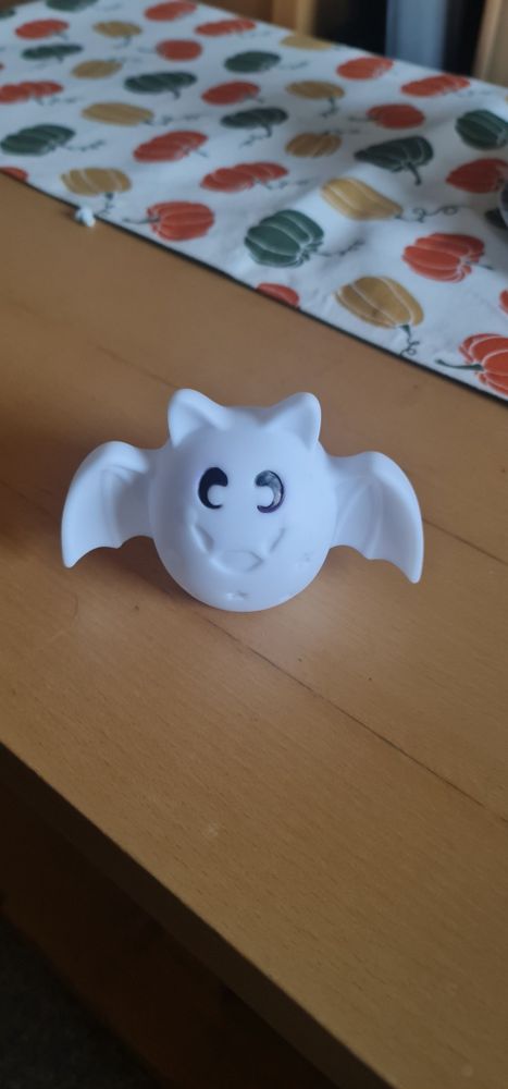 A white plastic bat toy