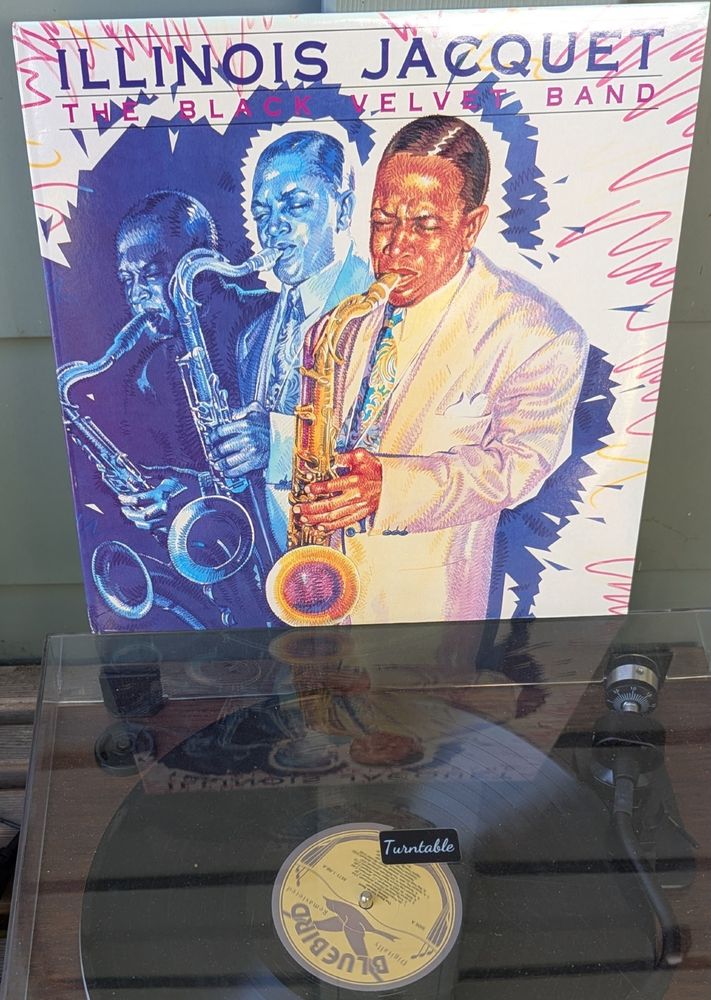 LP cover - A colored pencil illustration of a Black man (Jacquet) playing his tenor in triplicate -- three very similar poses next to each other. The primary one has Illinois in a light-colored 40s suit with wide lapels and a painted floral tie. The other two are in the same outfit but darker. They are surrounded by cut blue paper, and red and yellow squiggles like fireworks. 