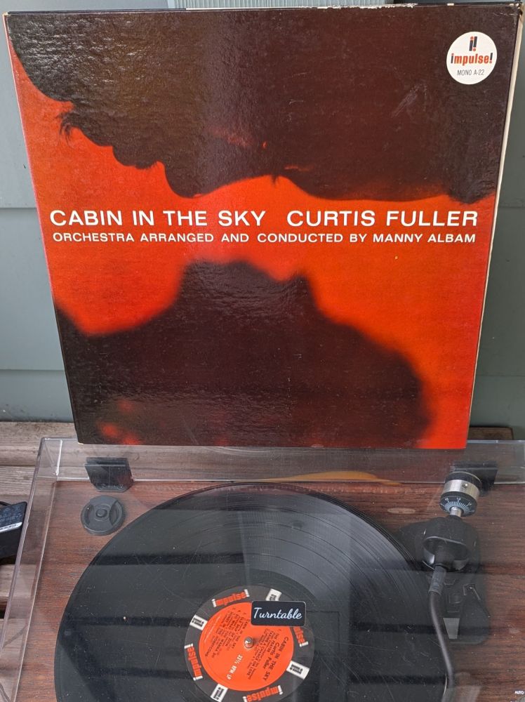 LP cover - A Black man (Fuller) and an out of focus Black woman in profile facing each other, almost in silhouette, against a brick red background. Fuller is extremely close up, and you can easily make out his eyelashes, mustache, and beard. The tip of his nose and lower and upper eyelid are catching a tiny bit of the red light. The cover is a beautiful laminated gatefold, as most Impulse! records of the time are.