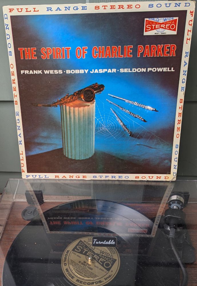 LP cover - now THIS is a cover. A terrible one, but it is a cover. It's mostly taken up by a photo of a segment of a Greek column with an alto sax laid on top, and three flutes of different sizes in the background. A spider web has been photo edited in behind the column. And the whole thing is lit up by an eerie blue light. Around the outside are repeated the words FULL RANGE STEREO SOUND on all four sides, in red and blue letters. The title is in red with white drop shadow. The World Wide logo in the upper right is too busy as well -- a big red bow tie shape with FULL RANGE STEREO on it in white, and a globe behind it. The back cover is a hoot, as well, with hundreds of tiny words about WHAT IS STEREO and WHY STEREO and HOW IS STEREO MADE, etc. 