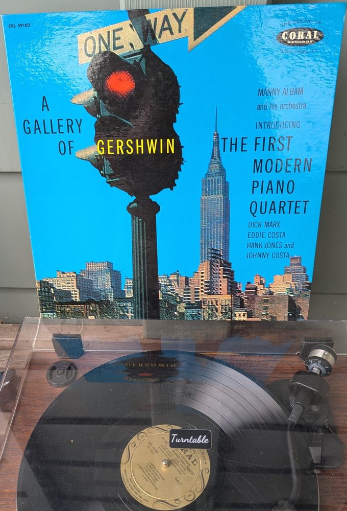LP cover - lovely laminated gatefold. The cover is a photo of New York, with the Empire State building towering over what is still mostly midrise midtown. A stoplight on a pole, old enough to have just two lights (green and red, no yellow) topped with a one way sign. The sky is a ludicrously fake bright, almost fluorescent blue.