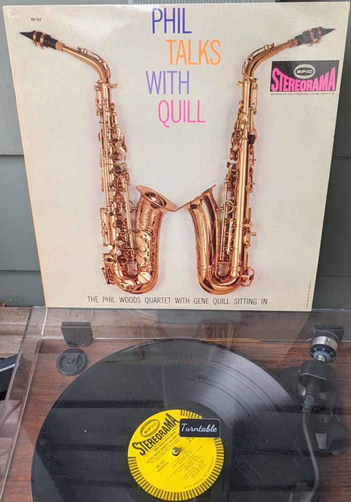 LP cover - Against a beige background, two alto saxophones are facing each other, with bells touching.