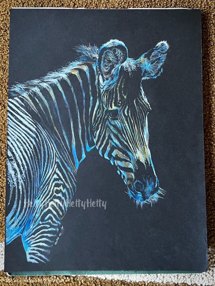 A zebra drawn on black paper using negative space. 