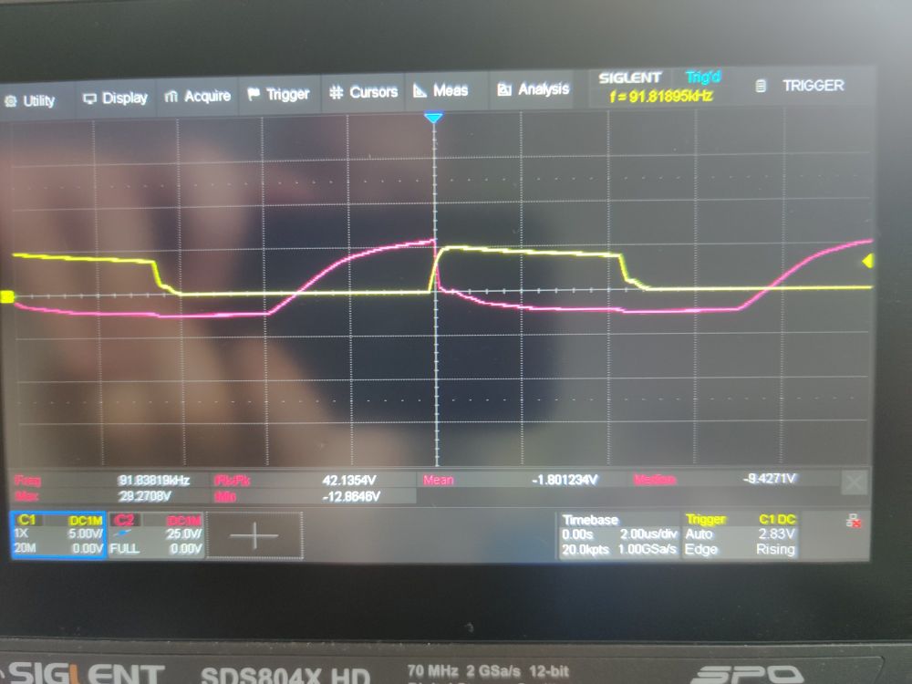 Oscilloscope showing the 555 timer output driving the transistor (yellow) and the transformer output (purple).