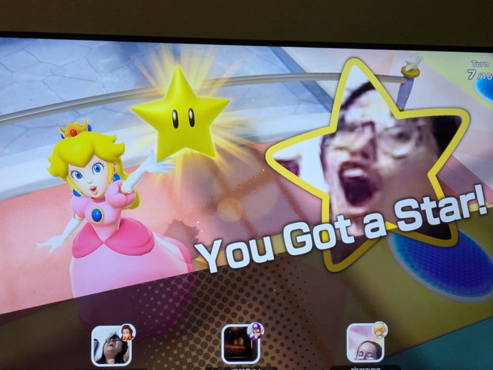 A group of friends plays Mario Party Jamboree TV Edition. Six gets a star and her on-screen face makes her look very excited if not very pixelated. 