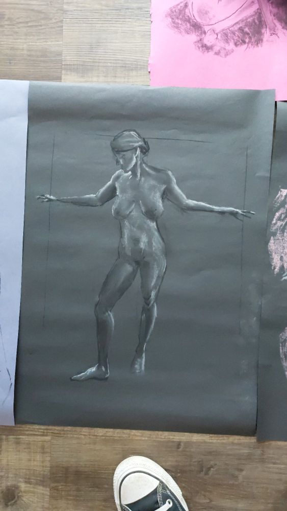 Charcoal and chalk on black paper drawing of a standing woman, front view
