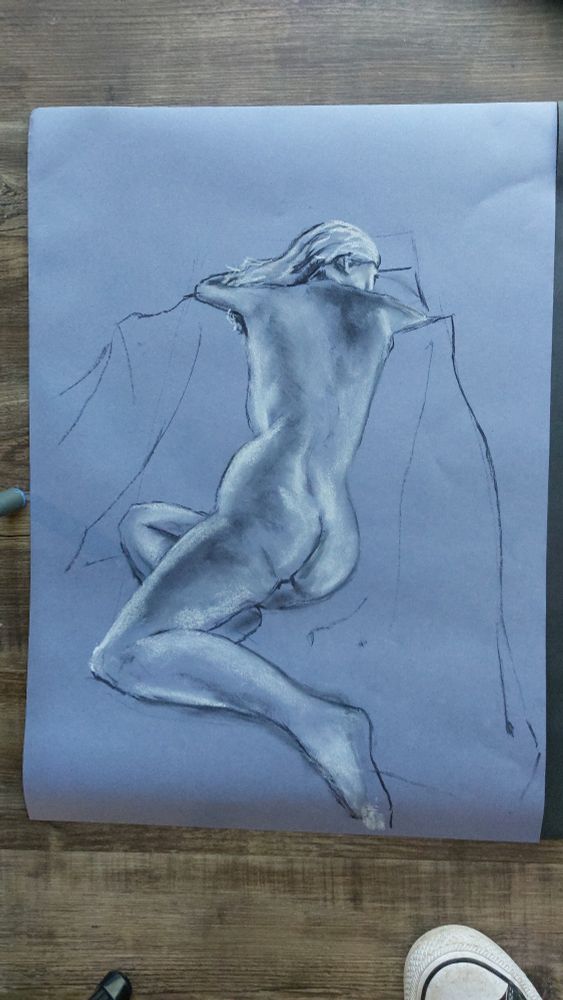 Charcoal and chalk drawing of a woman reclining 