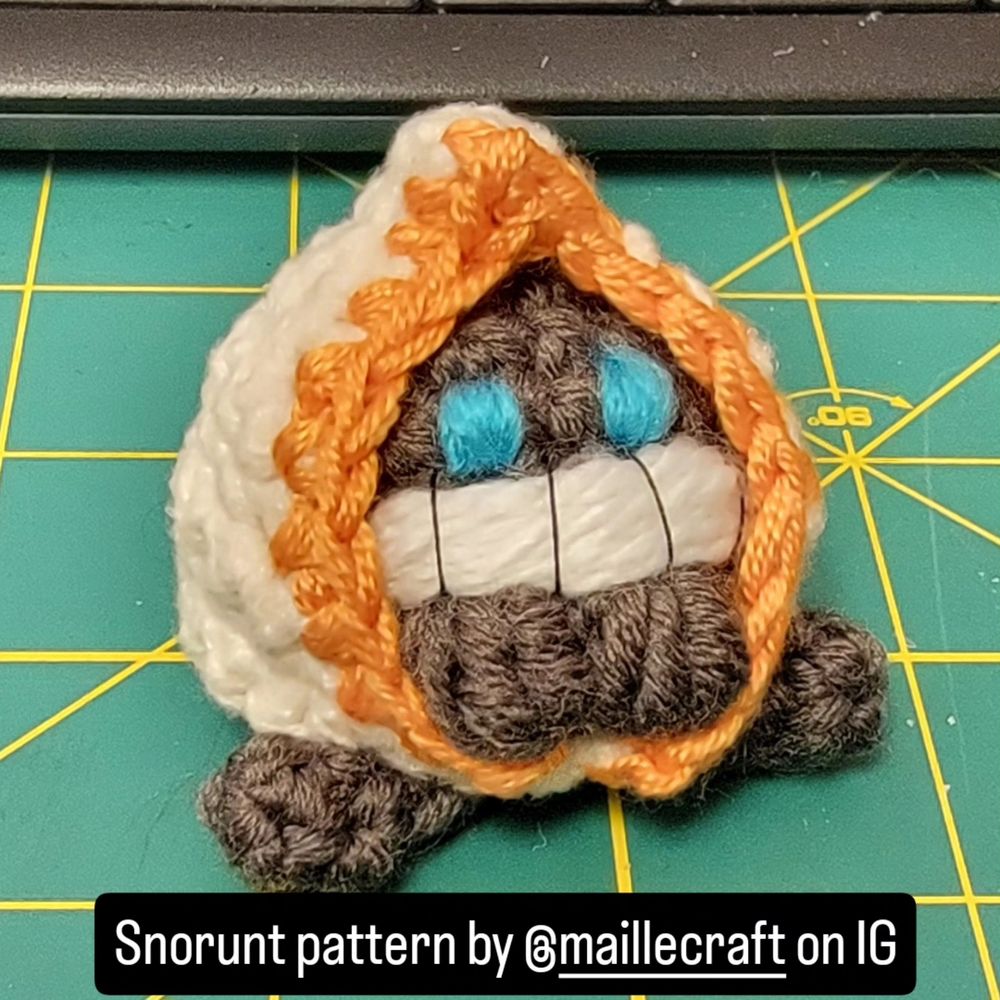 Crochet Pokémon Snorunt sitting on a green cutting mat