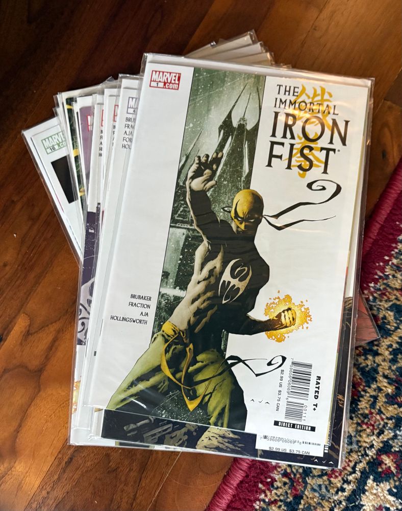 The Immortal Iron Fist (Marvel 2006) by Ed Brubaker, Matt Fraction, David Aja, & Travel Foreman. The first 6 issues of this “soft reboot” of the Iron Fist lore has the engaging return of Danny Rand along w/ the introduction of a long lost previous Iron Fist who walked away. 

Brubaker & Fraction put together a plot that draws the reader in like a spider web. It really is a hard to put down read. The intrigue of secret societies and a tournament of masters nods nicely to Hong Kong movies while seamlessly embedding it into Marvel’s universe. What may have been easily sledge-hammered into place is instead woven tightly and concisely with little, if any notice. This story easily stands alone and entertains w/o guest stars. 

The art is ridiculously perfect as well. Dramatic, simple and yet carrying an exotic feel that also honors the Hong Kong aesthetic,but  is also very modern, clear and appropriate. The storytelling is perhaps the most underrated aspect. Action tales can be easily dominated by said action. Here the balance of dramatic tension and physical action is balanced appropriately. Add gorgeous colors and the whole series ties into one very easy to follow story that’s very well drawn as well. 

The series runs thru #27. The whole series is worth the read, but these first 6 issues are what grabbed me and kept me in. 

Actual alt text - issues 1-6 of the Immortal Iron Fist on a wood floor. 