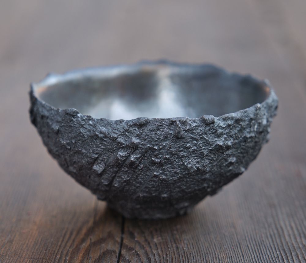 Bowl with very rough exterior. Thrown thick, allowed to dry to leather hard, then cut with a razor and the clay torn away.