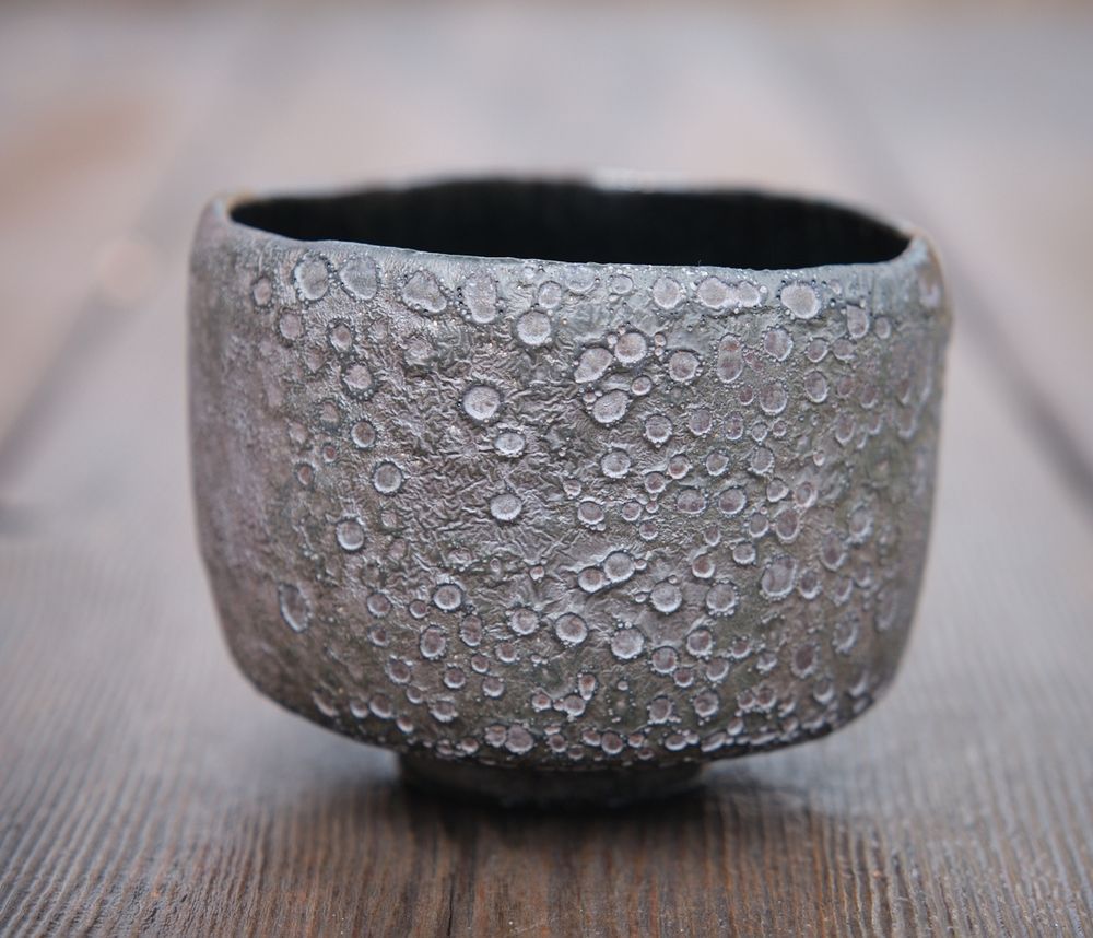 Front of teabowl showing the moon-like cratering in the glaze. I had to do a lot of cleanup with a grinder to make the surface smooth enough to use.
