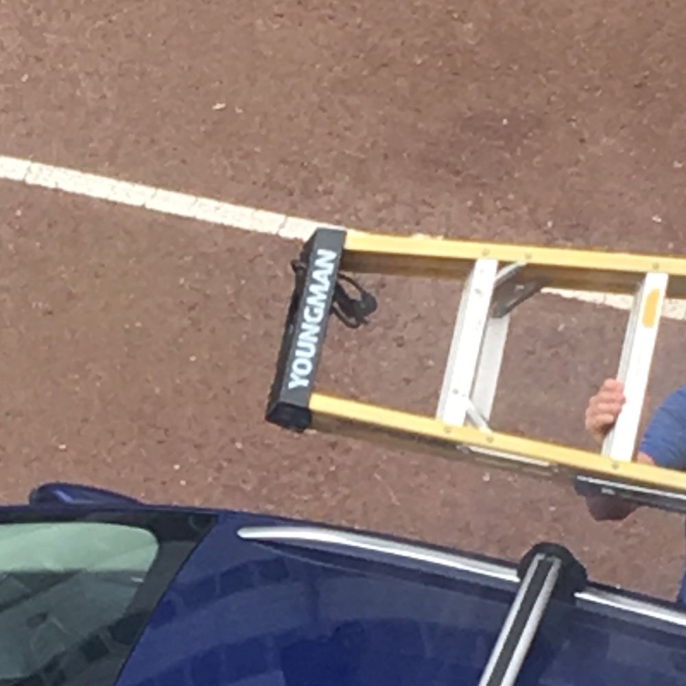 A pair of ladders in the ymca carpark that say youngman on them