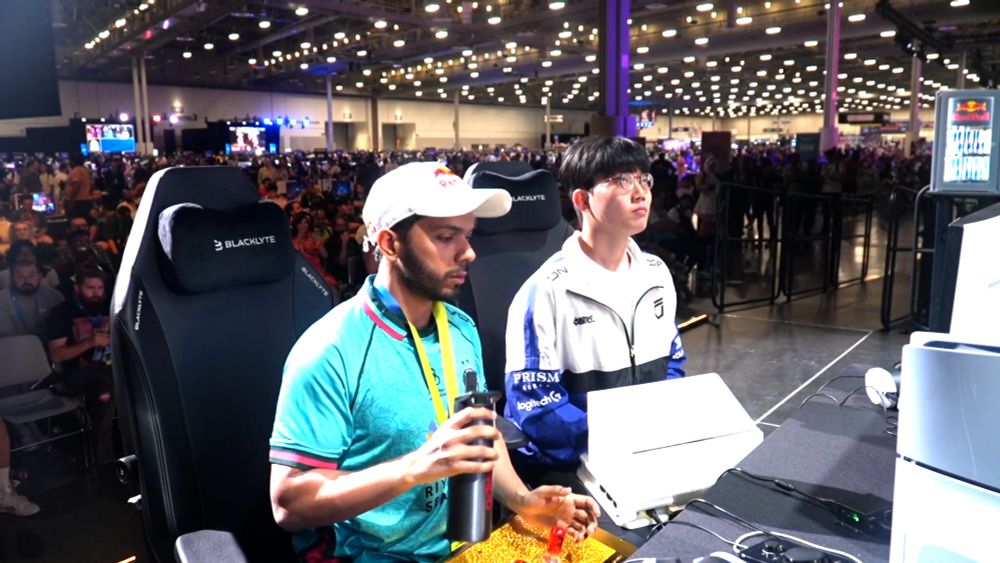 person puts hands inside a box to play a video game