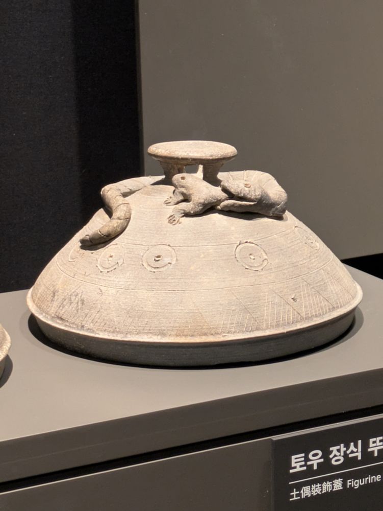 Pottery with a snake eating a frog