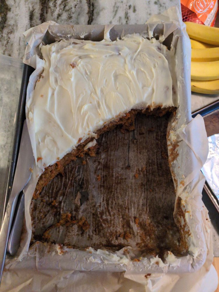 A carrot cake FOULY sliced on the diagonal by a MONSTER 