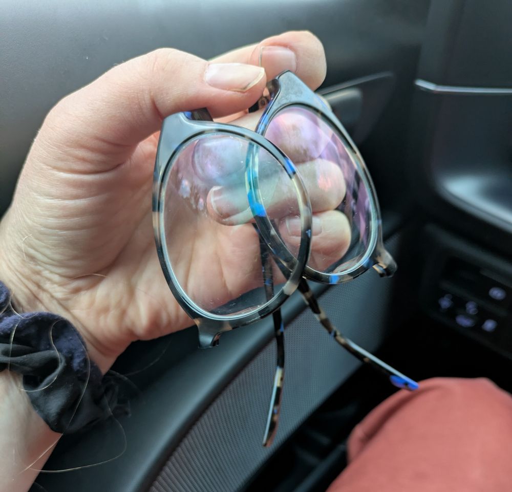 A pair of glasses broken in half