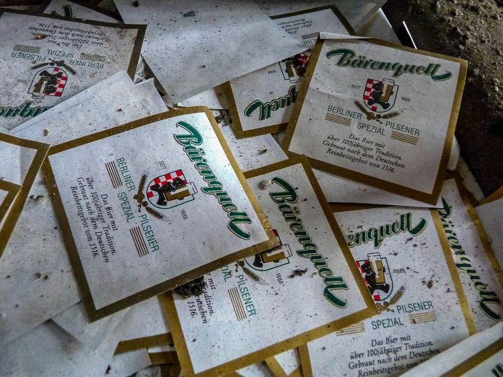 Discarded beer bottle labels bearing the old Bärenquell logo, which actually features a bear, so it’s bearing on more ways than one. Bärenquell means “spring of bears” so I guess we shouldn’t be surprised.