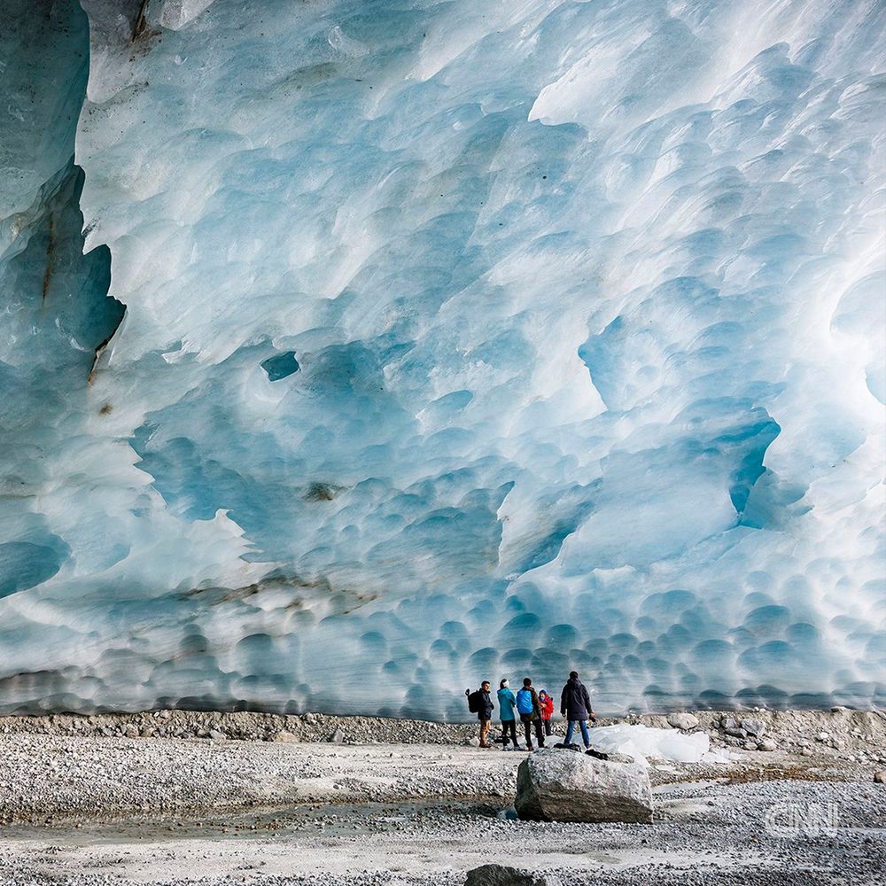 Tourists hike to visit the Nigardsbreen glacier in Jostedal, Norway, in August 2022. | Bram Janssen/AP/File photo