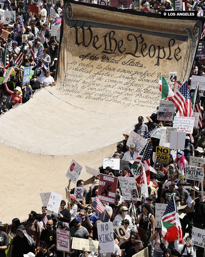Protesters in downtown Los Angeles carry a banner representing the Preamble to the US Constitution | Mario Tama/Getty Images
