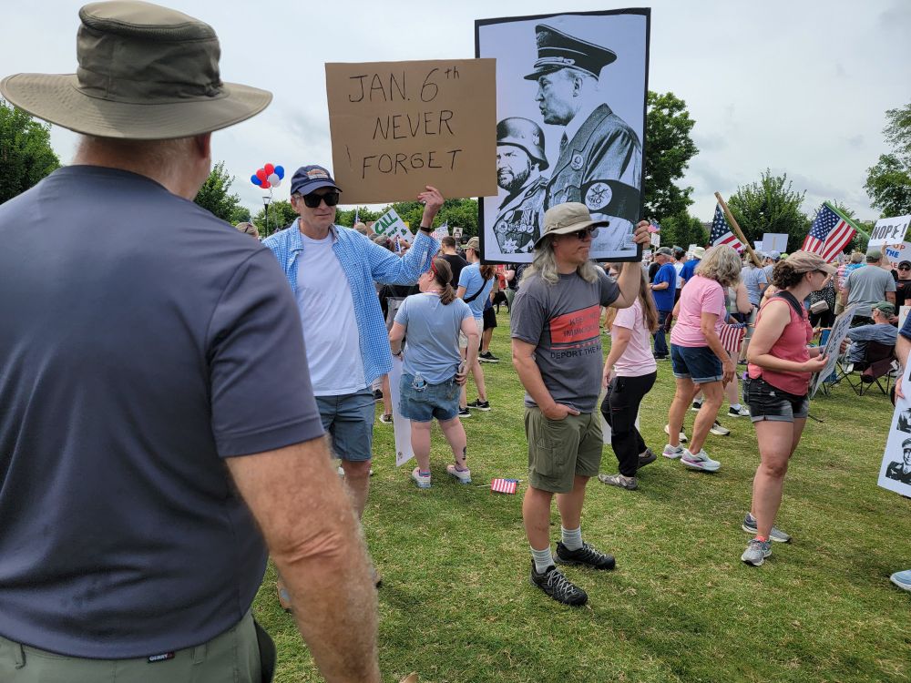 Protesters holding signs at Greenville, SC No Kings rally.