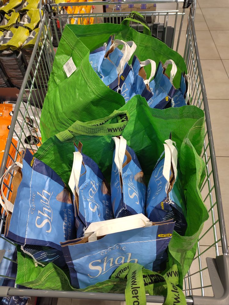 A shopping cart with 10 x 5kg cat litter bags