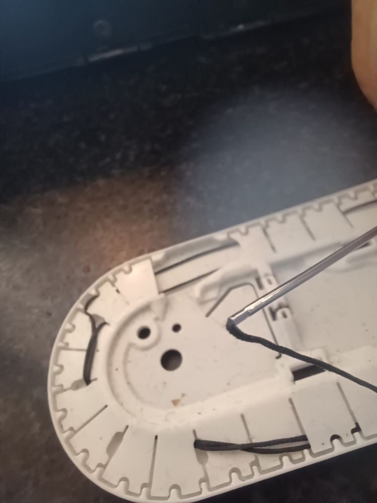 crimped needle end securing thread.