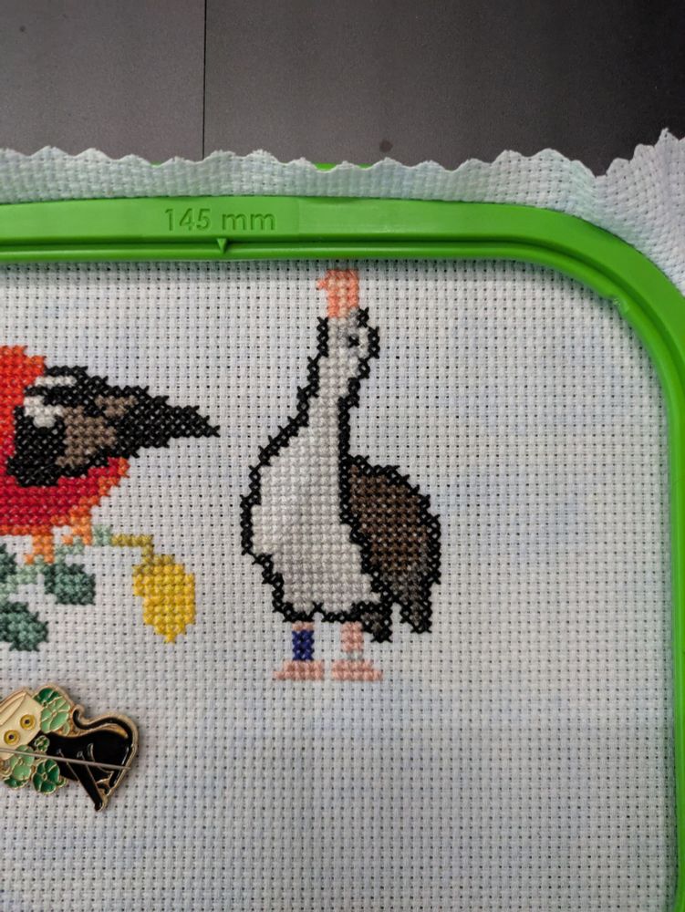 A cross stitch piece featuring a Laysan Albatross.