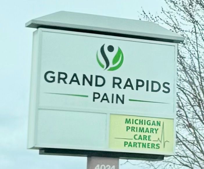 Business sign that reads, “Grand Rapids Pain”.