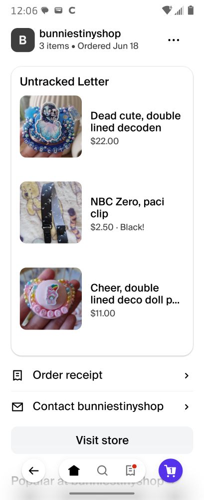 An order through Bunnie. 
A screenshot of said order, containing two pacifiers and a pacifier clip. 
The pacifier clip has a black base color, with little Zero's printed on it. 
The two pacifiers include Cheer bear from Care Bears and Emily from Corpse Bride.
One says Cheer and the other says Dead Cute.