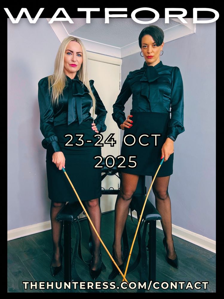 The Hunteress and Miss Jessica Wood stand either side of a whipping bench with canes in their hands, wearing matching silk blouses.  They will be doing sessions together and filming between 23-24 October. Application to be made via www.thehunteress.com/contact 