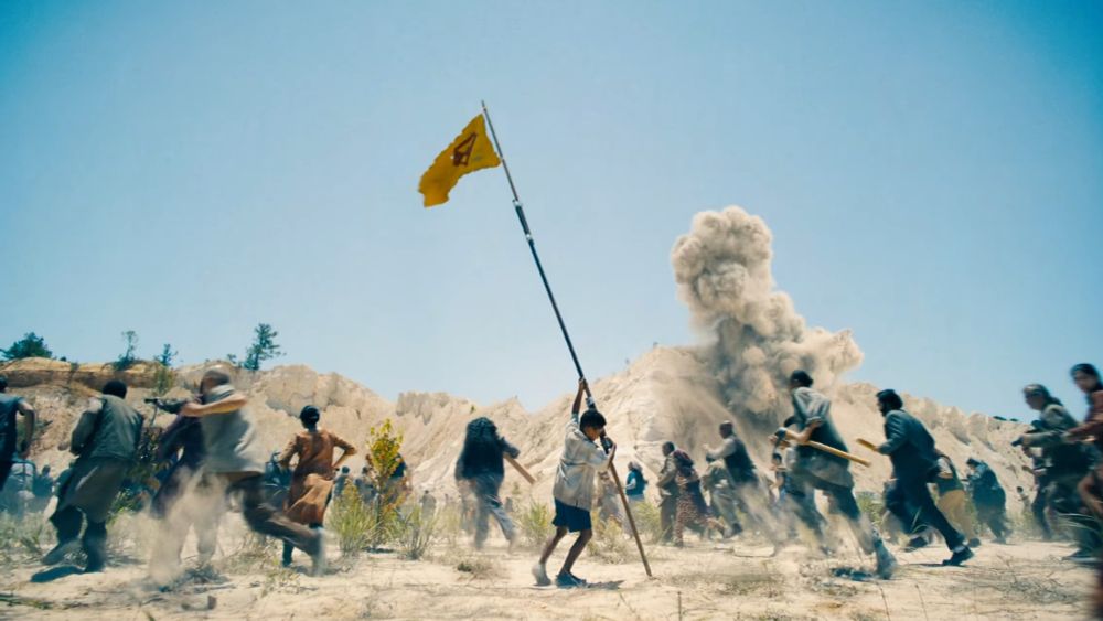 Kid holding a Superman flag. 