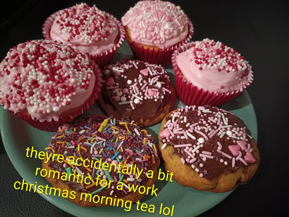 Closer up picture of the baked goods plate from the other image. I've written in yellow text on the image "theyre accidentally a bit romantic for a work christmas morning tea lol"
