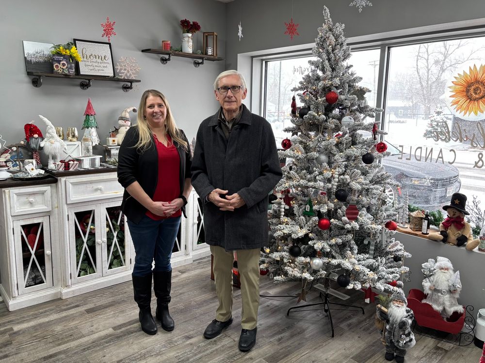 Gov. Evers poses for a photo with the owner of a small business 