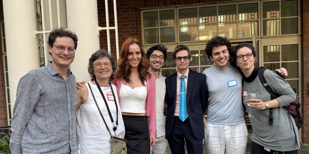 Five attendees of the Yale RNA Center summer party standing together smiling, with the event venue in the background
