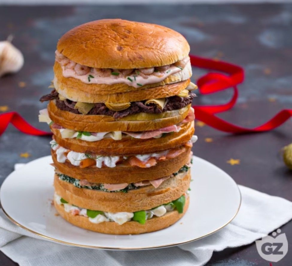 Hugely tall panettone sliced up like the ultimate club sandwich with six different delicious fillings. Served as a party starter dish, and (hopefully skillfully) cut vertically into wedges so you get every taste in each serving.