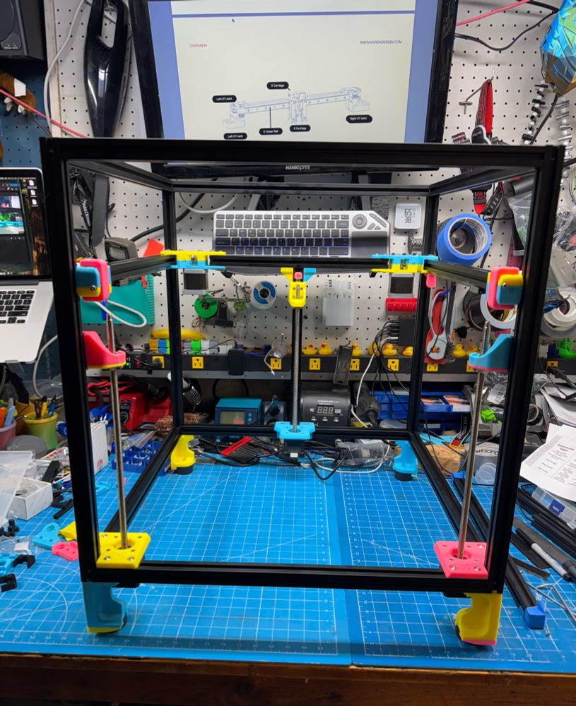 In progress Voron Trident 3D printer build, now with Z axis motors and feet mounted. 