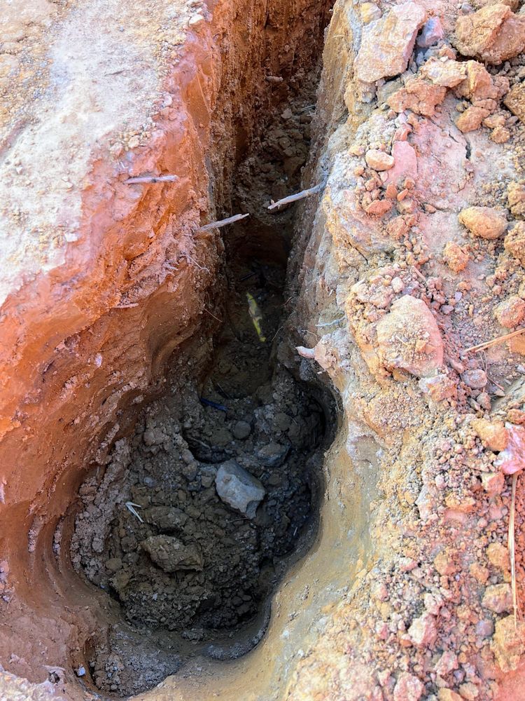 A hole in some dirt, with a trench leading away from it. I honestly don't remember if this was plumbing or electrical.