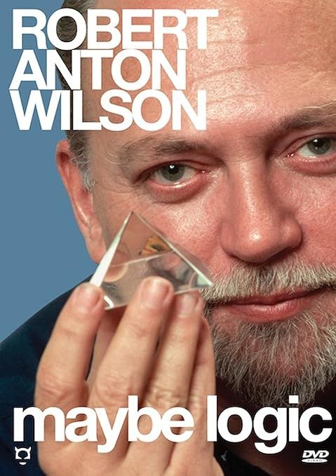 A close up picture of Robert Anton Wilson, holding a clear, pyramid-shaped, prism.