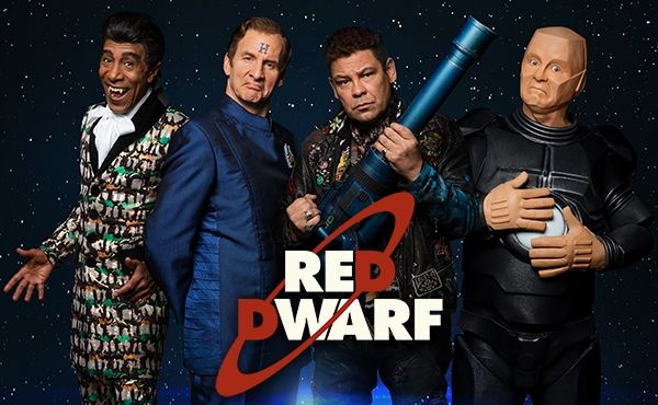 A picture of Cat, Rimmer, Lister, and Kryten posing with the Red Dwarf logo.