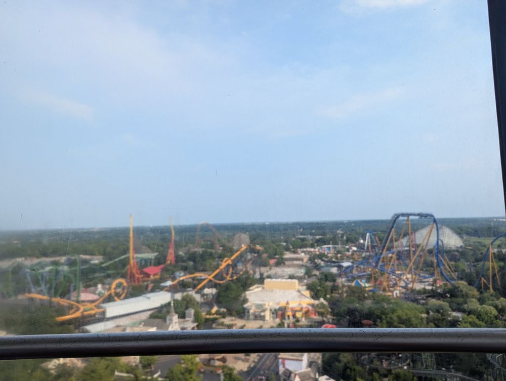A view of Six Flags Great America from the Sky Trek Tower. You can see: Joker, Batman, Flash, Goliath, Wrath of Rakshasa, Whizzer, American Eagle, and probably more (the window is rather dirty)