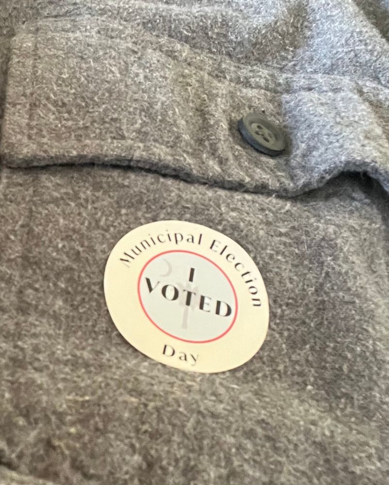 An “I Voted” sticker on a Grey Chamois shirt pocket 