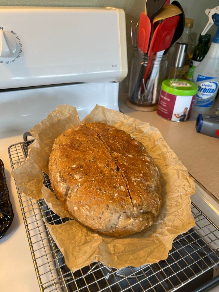 Oblong loaf of rye porridge-style bread on crinkly parchment paper.