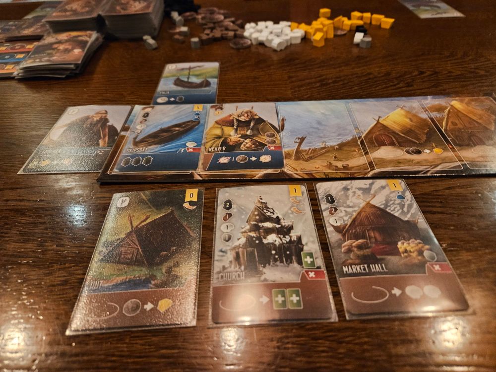 Shipwrights of the North Sea boardgame player board and some cards laid out. 