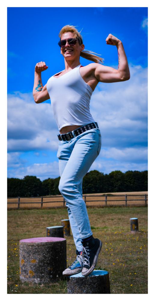 my bombshell girlfriend @ashleynova.space flexing against a blue sky looking buff as fuck 