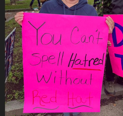 No Kings Rally sign, " You Can't Spell Hatred without Red Hat"