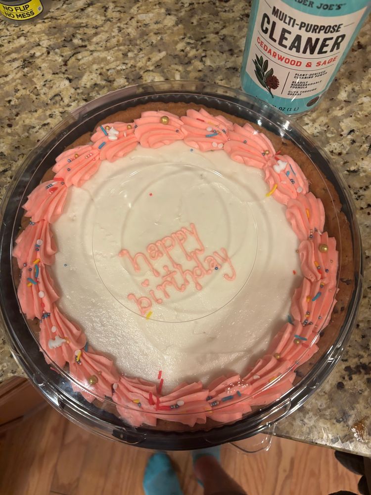 A cookie cake with happy birthday frosting