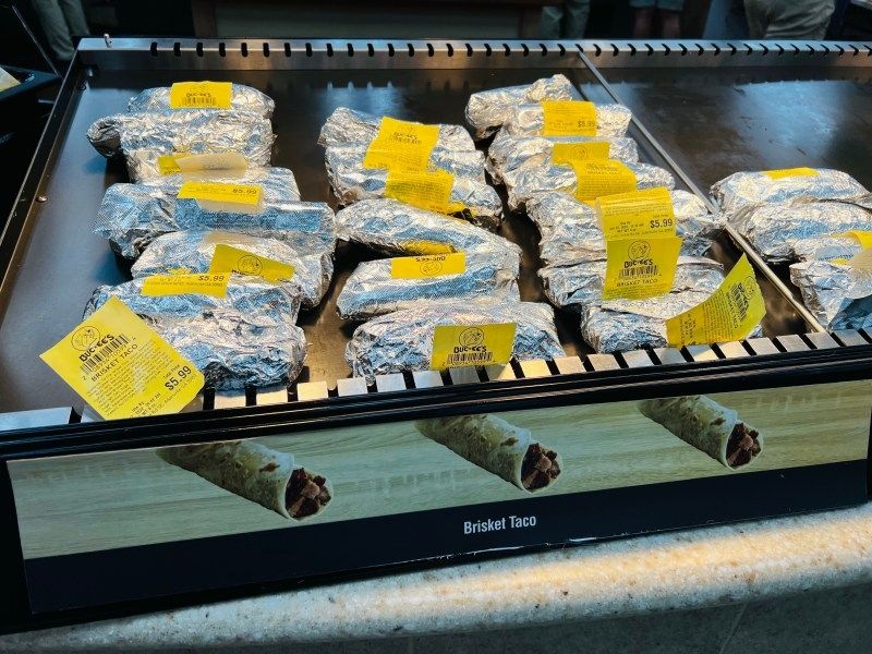 Four rows of tacos wrapped in labeled foil.