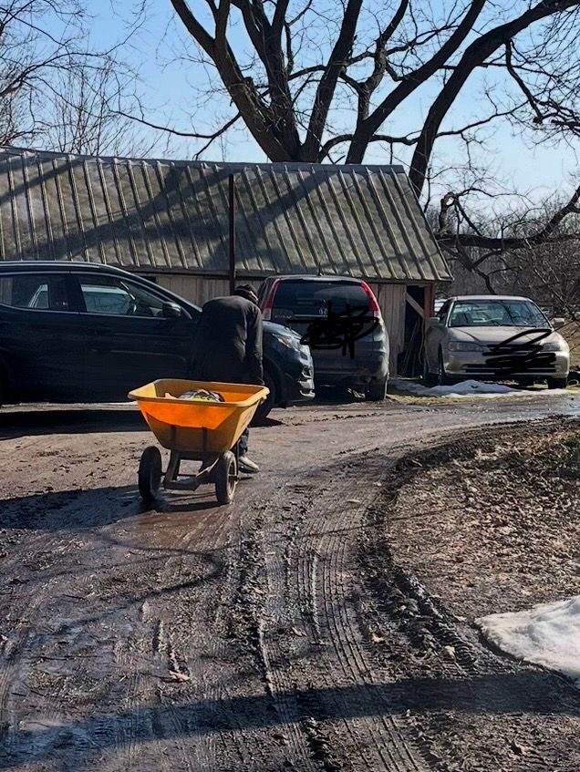 Pictured is a 88 year-old farmer pulling a wheelbarrow with over 88 pounds of livestock feed from the end of the driveway through mud to the barn. 